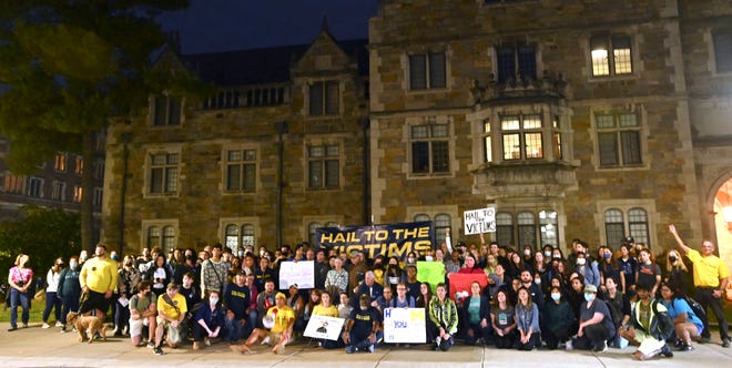 Sexual-assault survivors and supporters pose for a picture in front of the Lawyer's Club and Munger Residences building, Wednesday night, October 13, 2021.
