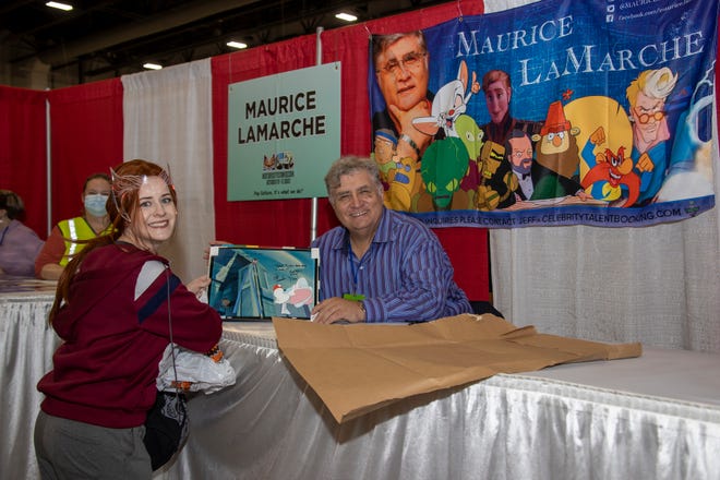 Voice actor Maurice Lamarche poses for a picture with Lisa Bernier of Clarkston during the Motor City Comic Con.