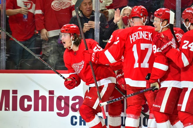The Red Wings' Tyler Bertuzzi (59) celebrates his fourth goal of the game with teammates.