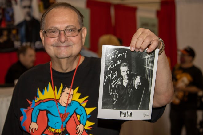 Gary Smith of Lauren, Ohio holds up his autographed picture of Michael Lee Aday, better known as Meat Loaf, during the Motor City Comic Con event at the Suburban Collection Showplace in Novi, Friday.