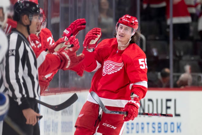 Red Wings left wing Tyler Bertuzzi high-fives his teammates after scoring the first of three goals during the second period.