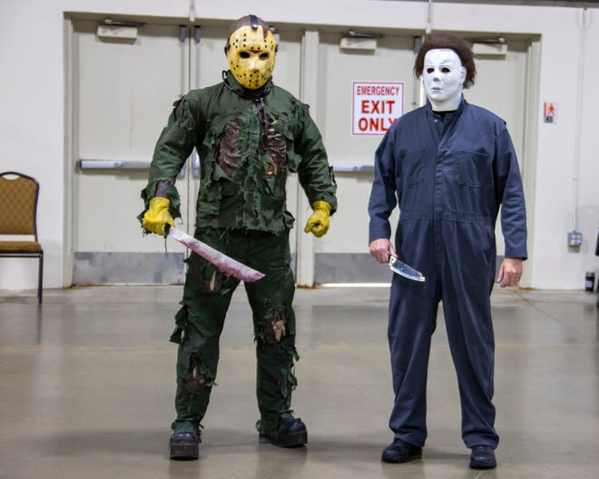 A couple of scary dudes guard the exit doors during the Motor City Comic Con, Jason Voorhees from Friday the Thirteenth and Michael Myers from Halloween.