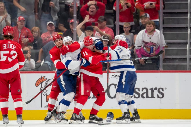 Red Wings center Pius Suter, left, and right wing Filip Zadina fight with Lightning defenseman Ryan McDonagh, left, and center Anthony Cirelli during the second period.