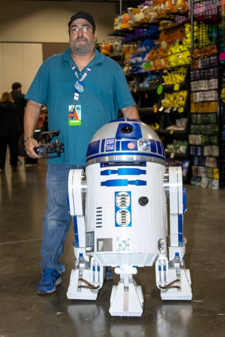 Michael Ingold of Redford stands by his hand build exact replica of Star Wars droid R2D2 during the Motor City Comic Con event at the Suburban Collection Showplace on October 15, 2021.