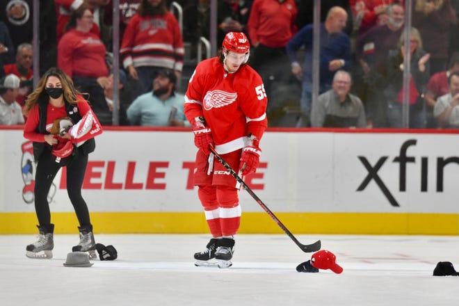 Red Wings forward Tyler Bertuzzi helps pick up hats on the ice after his hat trick in the second period against the Lightning.