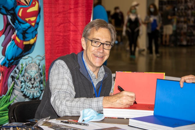 American comic book writer and artist Dan Jurgens signs autographs during Motor City Comic Con.