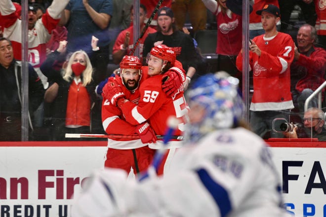 The Red Wings' Tyler Bertuzzi (59) celebrates his fourth goal of the game with teammate Nick Leddy.