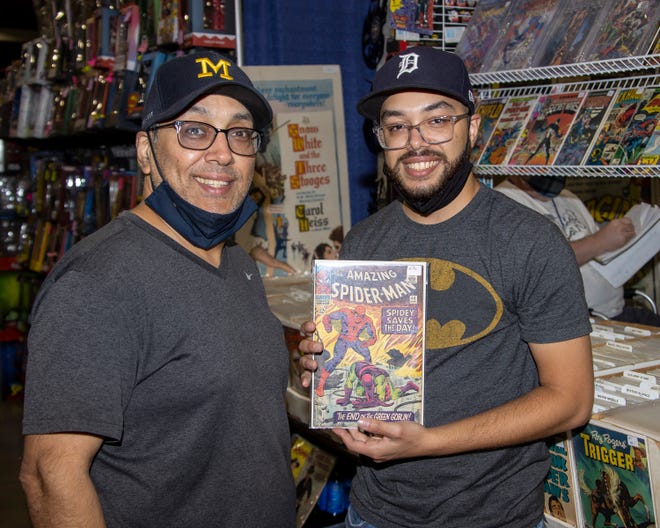 Father and son, Victor and Mateo Diaz of Detroit, enjoy collecting comic books together during the Motor City Comic Con event.