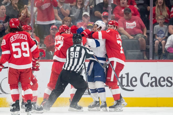 The Red Wings and Lightning mix it up during a scrum in the first period.