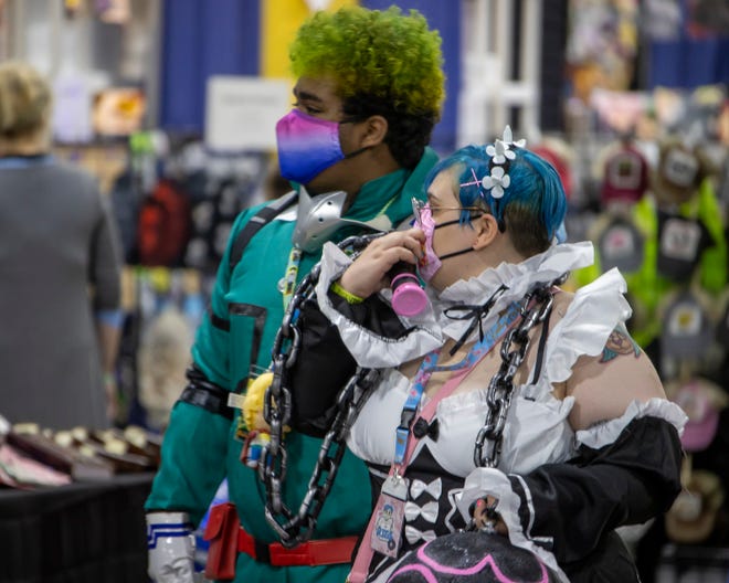 Comic fans wear elaborate costumes to walk around during the Motor City Comic Con event at the Suburban Collection Showplace in Novi.