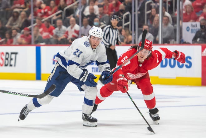 Tampa Bay center Brayden Point and Detroit left wing Tyler Bertuzzi battle for a bouncing puck during overtime.