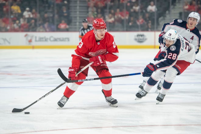 Detroit left wing Lucas Raymond keeps the puck away from Columbus right wing Oliver Bjorkstrand during the first period.