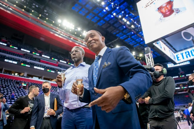 Former Detroit Pistons Ben Wallace, left, and Isiah Thomas participate in a ceremony at a court-side bar before the start of the Pistons’ season home opener against the Chicago Bulls, at Little Caesars Arena, in Detroit, October 20, 2021.