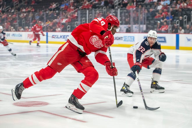 Detroit right wing Givani Smith tries to get a shot past Columbus defenseman Jake Bean during the first period.