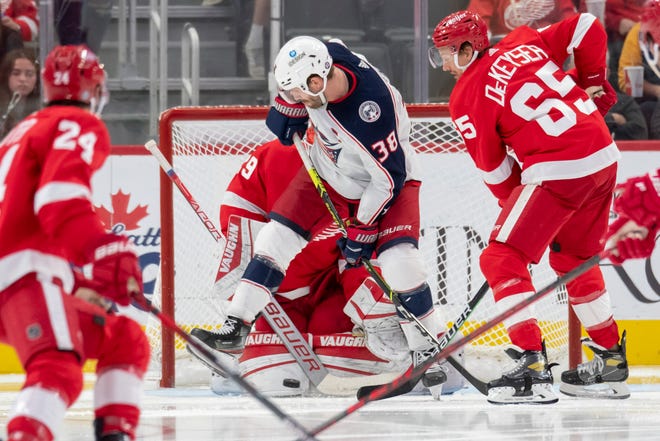 Columbus center Boone Jenner tries to deflect the puck past Detroit goaltender Thomas Greiss during the third period of a game between the Detroit Red Wings and the Columbus Blue Jackets at Little Caesars Arena, in Detroit, October 19, 2021.