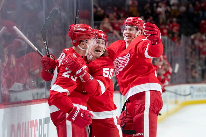 (From left) Detroit left wing Lucas Raymond, left wing Tyler Bertuzzi, and defenseman Moritz Seider celebrate Raymond’s first career NHL goal during the third period of a game between the Detroit Red Wings and the Columbus Blue Jackets at Little Caesars Arena, in Detroit, October 19, 2021.