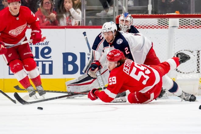 Detroit left wing Tyler Bertuzzi dives for the puck ahead of defenseman Andrew Peeke during the second period.