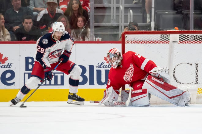 Columbus right wing Oliver Bjorkstrand tries to get the puck past Detroit goaltender Thomas Greiss during the third period of a game between the Detroit Red Wings and the Columbus Blue Jackets at Little Caesars Arena, in Detroit, October 19, 2021.