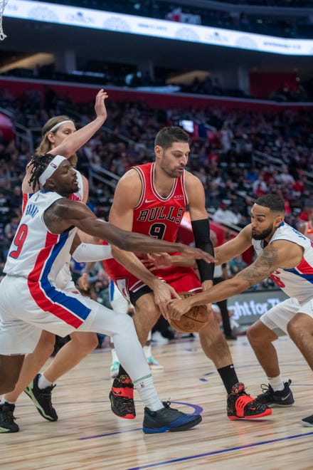 Chicago center Nikola Vucevic is defended by (from left) Detroit forward Jerami Grant, forward Kelly Olynyk and guard Cory Joseph during the first quarter.