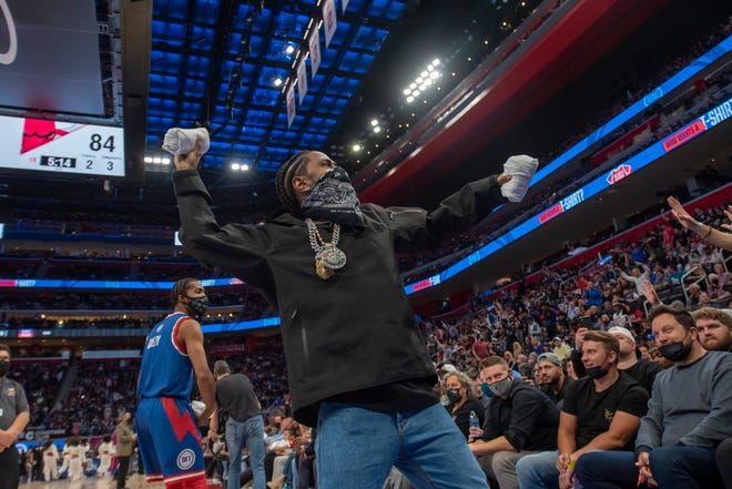 Rapper Big Sean throws t-shirts to the fans during the fourth quarter.