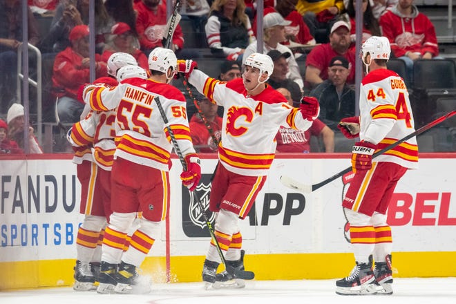 Calgary celebrates a goal by center Elias Lindholm during the first period of a game between the Detroit Red Wings and the Calgary Flames, at Little Caesars Arena, in Detroit, October 21, 2021.