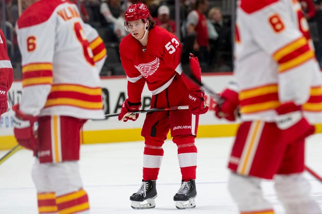 Detroit defenseman Moritz Seider watches Calgary celebrate after the Red Wings lost to the Flames 3-0 at Little Caesars Arena, in Detroit, October 21, 2021.