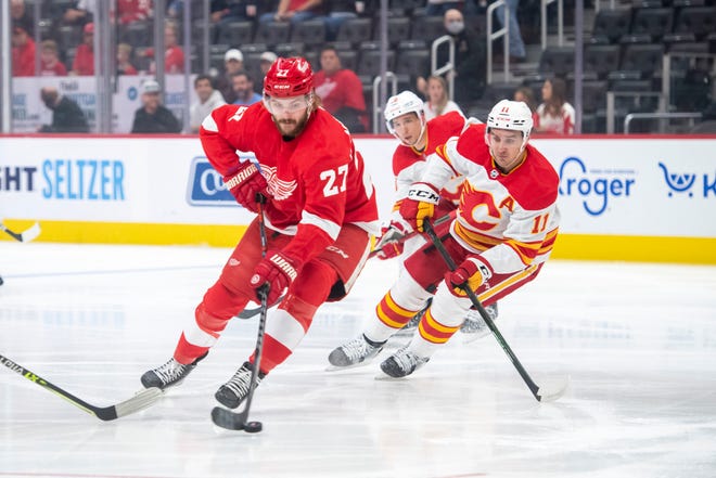 Detroit center Michael Rasmussen moves the puck down the ice during the first period of a game between the Detroit Red Wings and the Calgary Flames, at Little Caesars Arena, in Detroit, October 21, 2021.