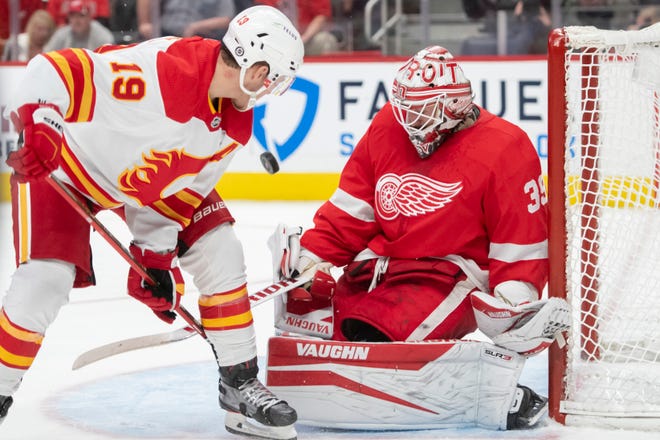 Calgary left wing Matthew Tkachuk tries to get the puck past Detroit goaltender Alex Nedeljkovic during the second period of a game between the Detroit Red Wings and the Calgary Flames, at Little Caesars Arena, in Detroit, October 21, 2021.