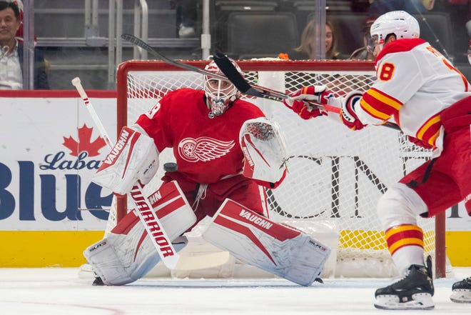 Detroit goaltender Alex Nedeljkovic keeps his eye on the puck during the first period of a game between the Detroit Red Wings and the Calgary Flames, at Little Caesars Arena, in Detroit, October 21, 2021.