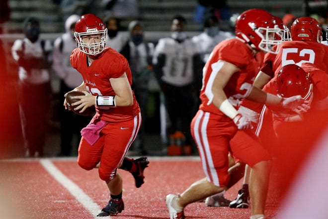 Orchard Lake St. Mary’s Brayden Ledin (12) rolls out of the pocket during their high school football game against Detroit Cass Tech on Thursday, October 21, 2021 at Orchard Lake St. Mary's High School in West Bloomfield Township.