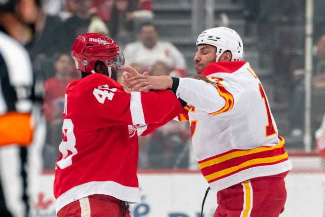 Detroit right wing Givani Smith and Calgary left wing Milan Lucic get into a fight during the first period of a game between the Detroit Red Wings and the Calgary Flames, at Little Caesars Arena, in Detroit, October 21, 2021.