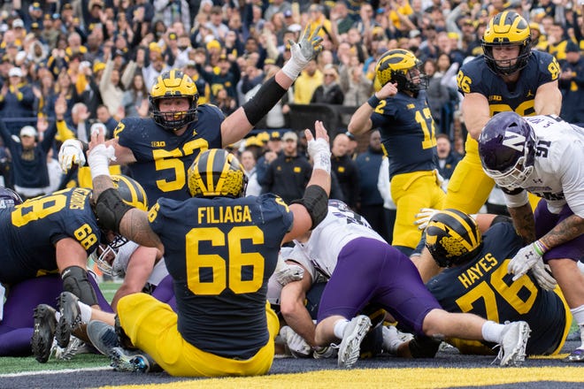 Michigan celebrates a touchdown by running back Blake Corum during the second quarter.