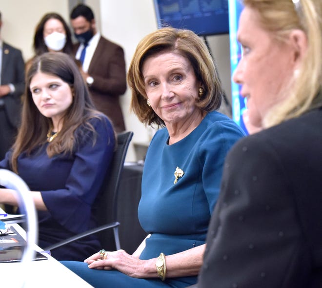 US Congresswoman Haley Stevens, left, and US House Speaker Nancy Pelosi, center, listen as US Congresswoman Debbie Dingell, right, addresses the media during the roundtable discussion at the Michigan Manufacturing Technology Center in Plymouth, Saturday afternoon October 23, 2021.