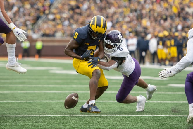 Michigan wide receiver Mike Sainristil fumbles the ball on this play with Northwestern defensive back Coco Azema in the final moments of the second quarter.
