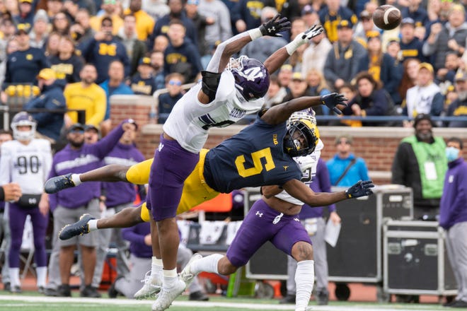 Michigan wide receiver Mike Sainristil is unable to catch this pass while under pressure from Northwestern defensive back Coco Azema during the first quarter.