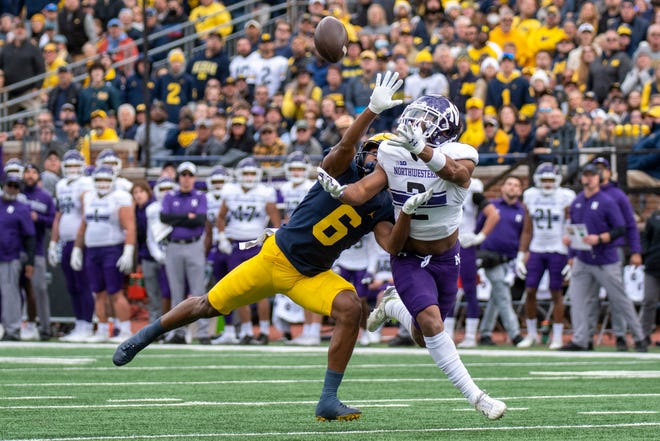 Michigan wide receiver Cornelius Johnson is unable to catch this pass while being defended by Northwestern defensive back Cameron Mitchell during the first quarter.