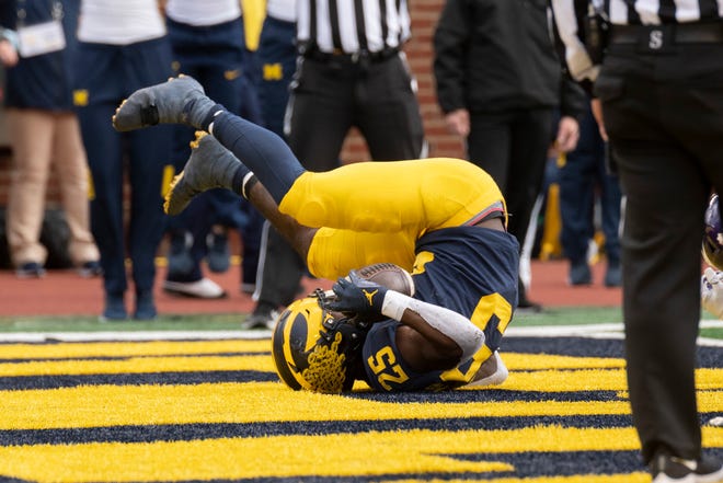 Michigan running back Hassan Haskins lands in the end zone for a touchdown during the fourth quarter.