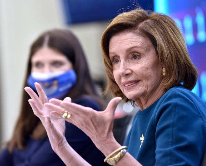 US Congresswoman Haley Stevens, left, listens as US House Speaker Nancy Pelosi talks at the roundtable meeting, Saturday afternoon October 23, 2021.