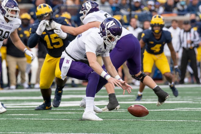 Northwestern quarterback Ryan Hilinski chases after the football after he fumbled it during the third quarter.