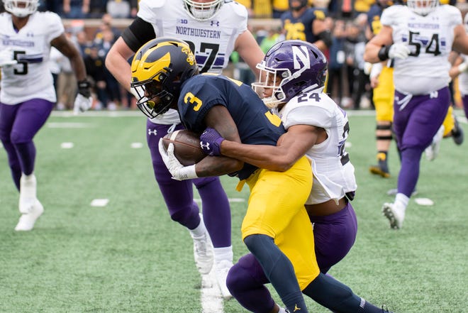 Michigan wide receiver A.J. Henning is tackled by Northwestern defensive back Rod Heard II during the first quarter.