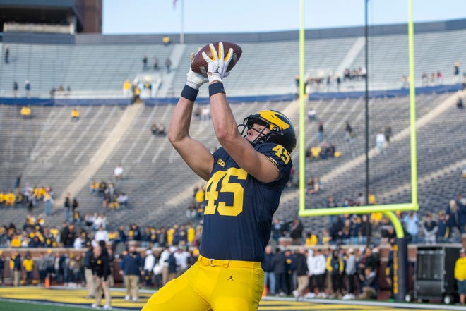Michigan tight end Noah Howes catches a pass during pregame warm-ups.