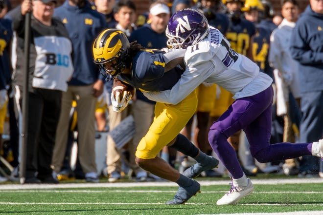 Michigan wide receiver Andrel Anthony is tackled by Northwestern defensive back A.J. Hampton Jr. during the third quarter.