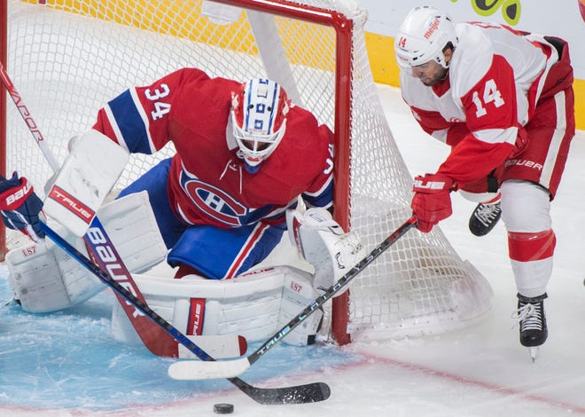 Detroit Red Wings' Robby Fabbri (14) moves in on Montreal Canadiens goaltender Jake Allen during the first period of an NHL hockey game Saturday, Oct. 23, 2021, in Montreal.