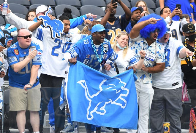 Lions fans mug for the cameras before Detroit takes on the Los Angeles Rams at SoFi Stadium.