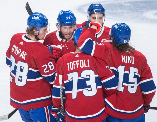 Montreal Canadiens' Mike Hoffman (68) celebrates with teammates after scoring against the Detroit Red Wings during the first period.