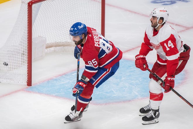 Canadiens' Mathieu Perreault (85) scores on an empty net as Red Wings' Robby Fabbri trails during the third period.