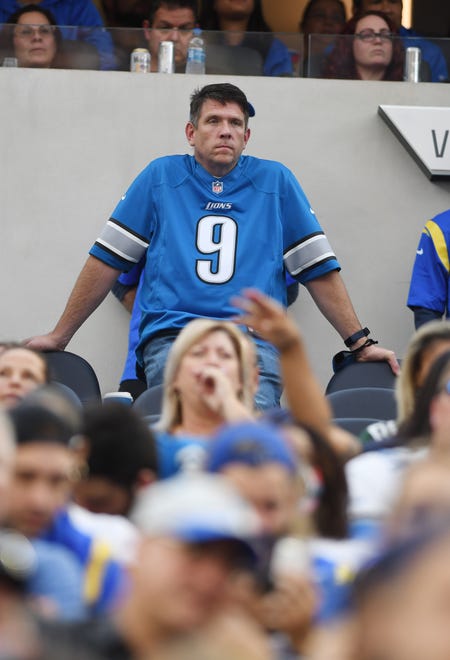 A fan wearing a Detroit Lions Matthew Stafford jersey can only watch as Detroit drops another game, this one on the arm of Stafford, 28-19.