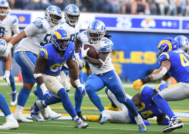 Lions running back Jamaal Williams finds a hole in the Rams defense and heads up field in the fourth quarter.