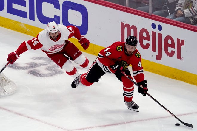 Blackhawks defenseman Calvin de Haan, right, looks to a pass past Red Wings center Robby Fabbri during the first period.