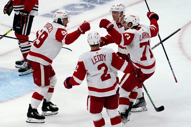 Red Wings left wing Tyler Bertuzzi, left, celebrates with teammates after scoring a goal against the Blackhawks during the second period.